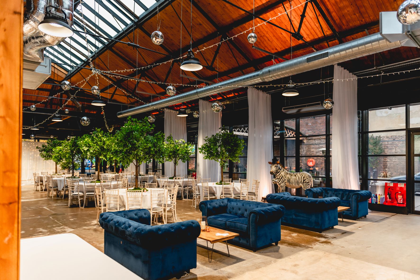 Wedding venue with high ceilings, ideal for celebrations and networking events. - Banner