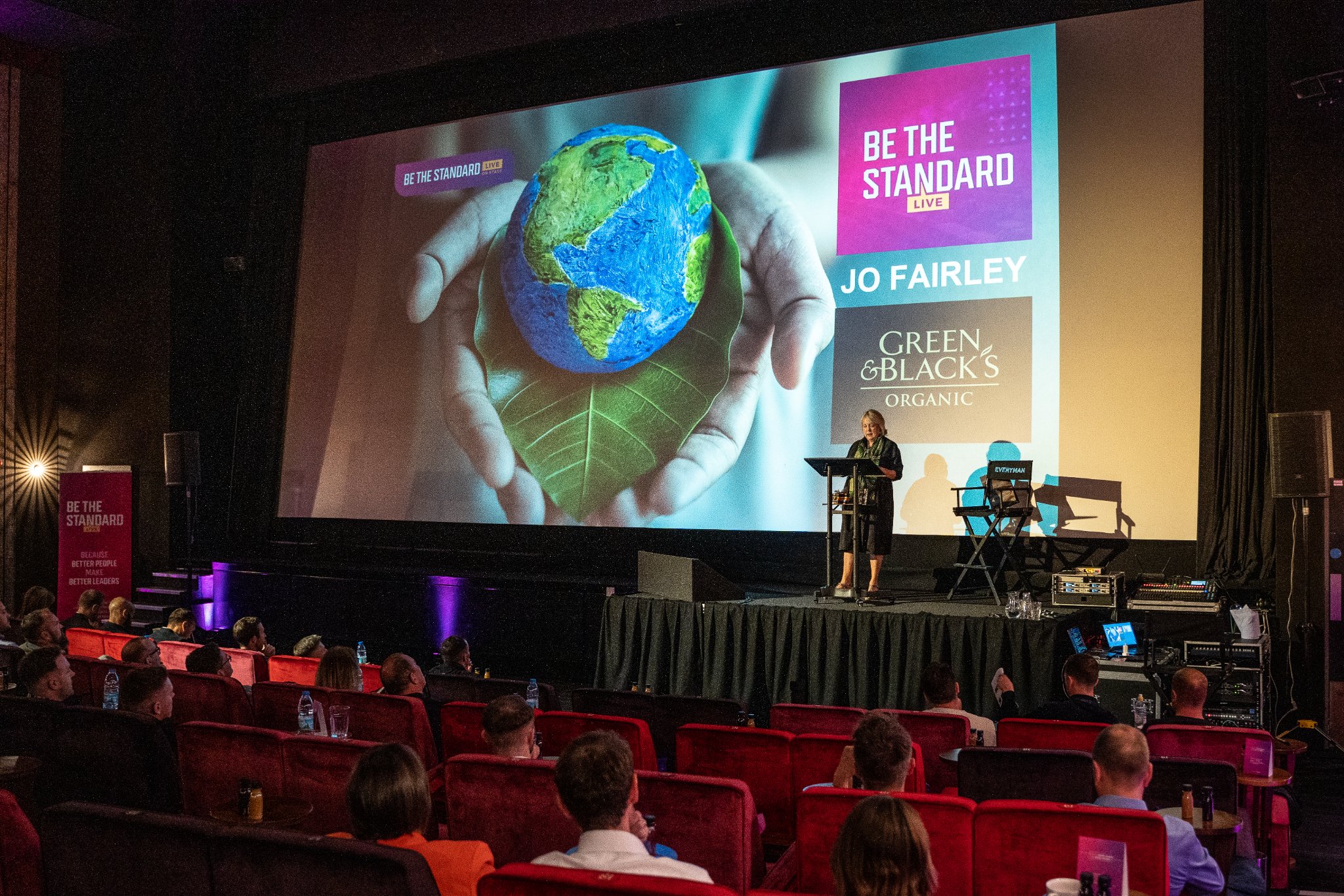 Everyman Leeds event with speaker, engaging audience, and "Be the Standard" theme. - Banner