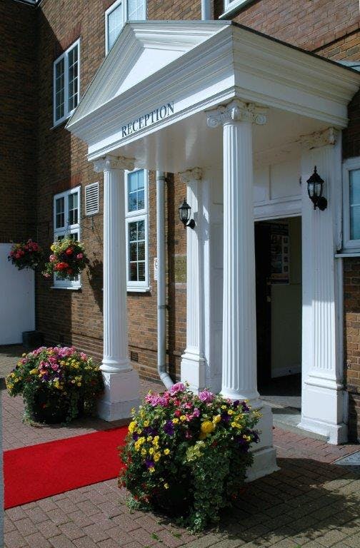 Manor Suite entrance at Quality Hotel Coventry with white columns, perfect for events.