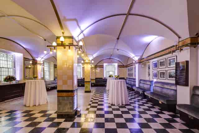Café Duke event space with elegant archways, perfect for networking and cocktail receptions.