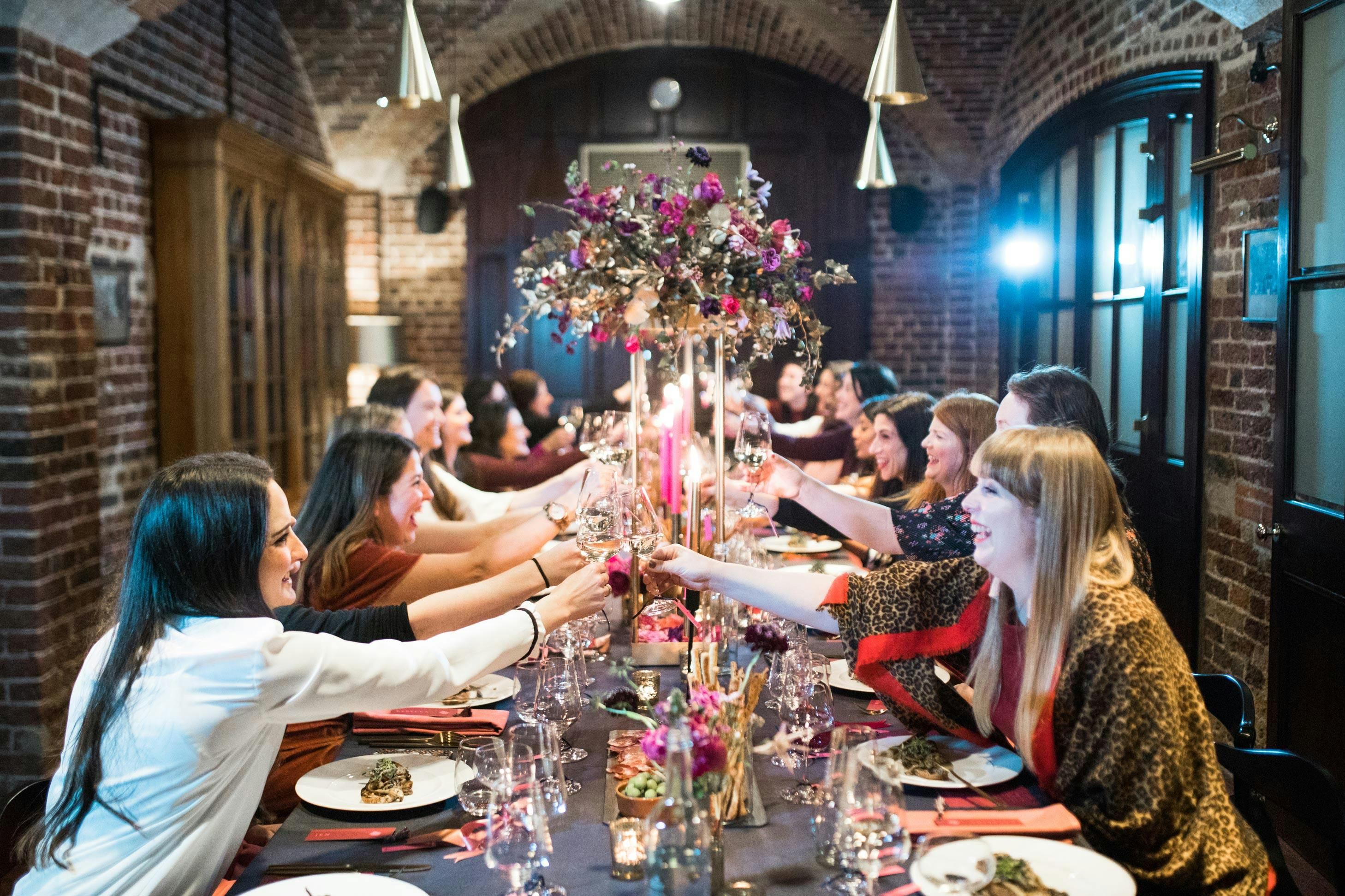 Elegant dinner setting at Café Duke, floral centerpieces for upscale events and gatherings.