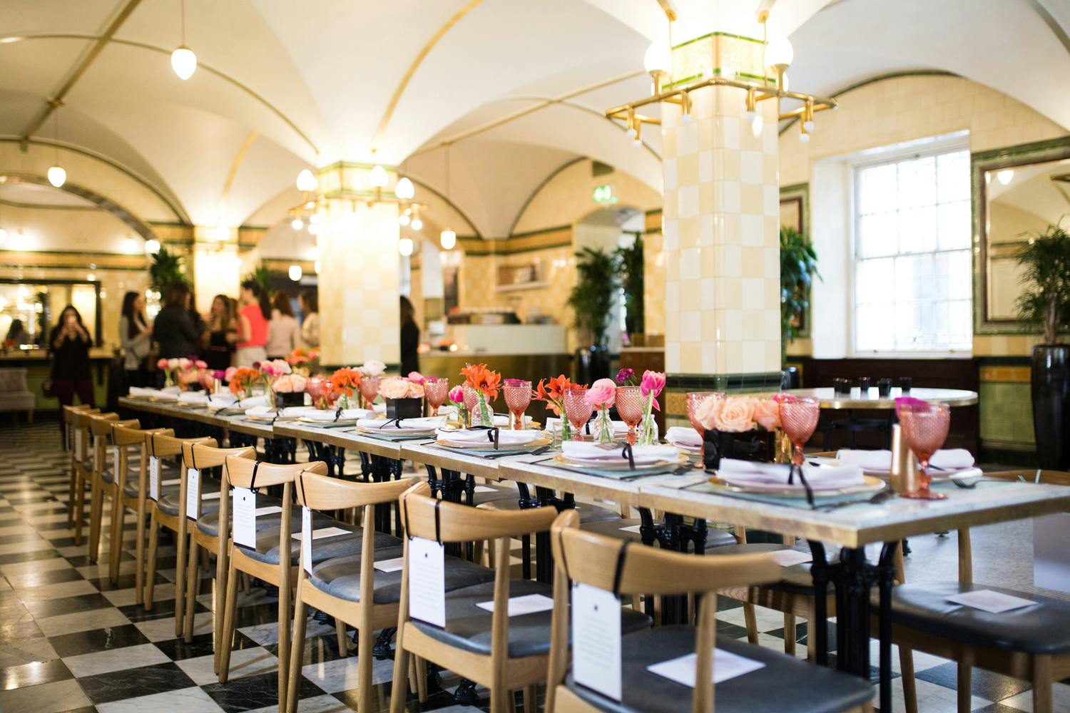 Elegant dining space at Café Duke with floral centerpieces for corporate events.