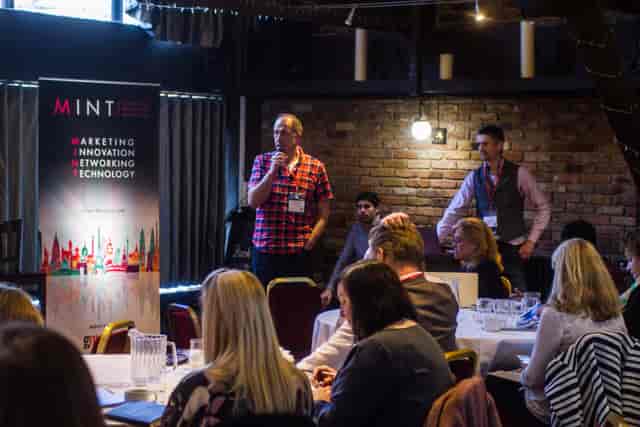Dynamic event in Dickens Inn with speaker engaging audience, highlighting marketing and technology.