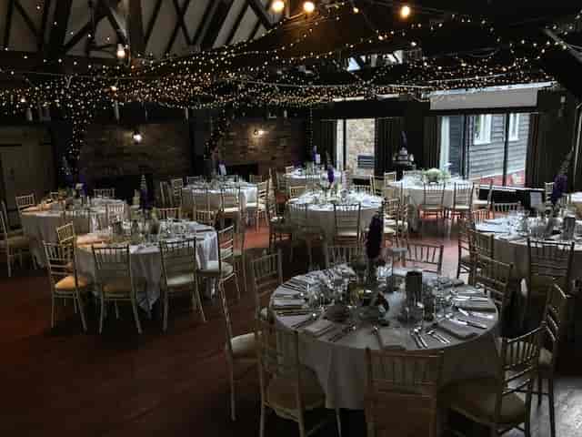 Elegant event space at Dickens Inn, perfect for weddings with round tables and fairy lights.