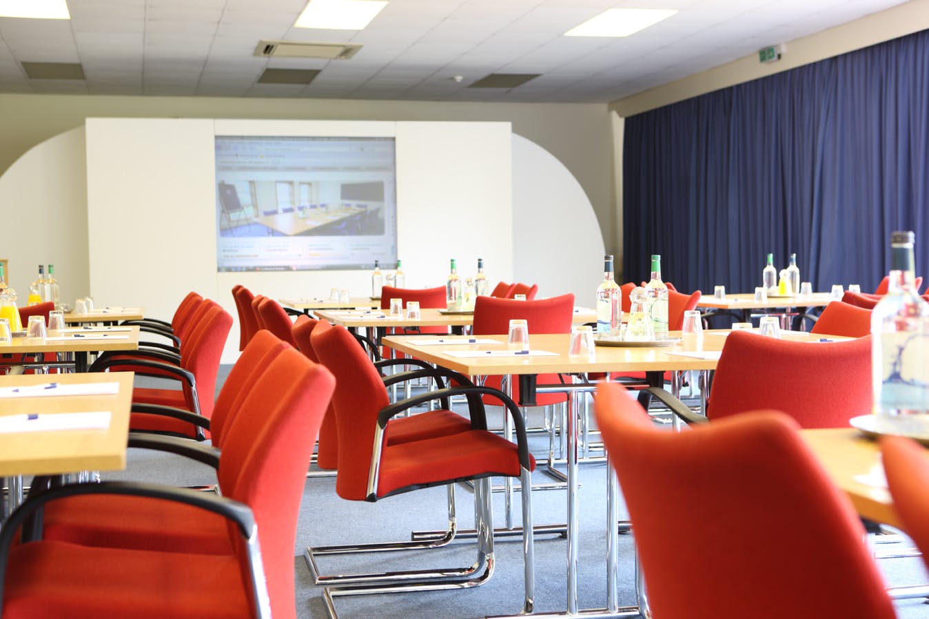 Oak & Cedar Suite meeting room with red chairs, ideal for professional events and presentations.