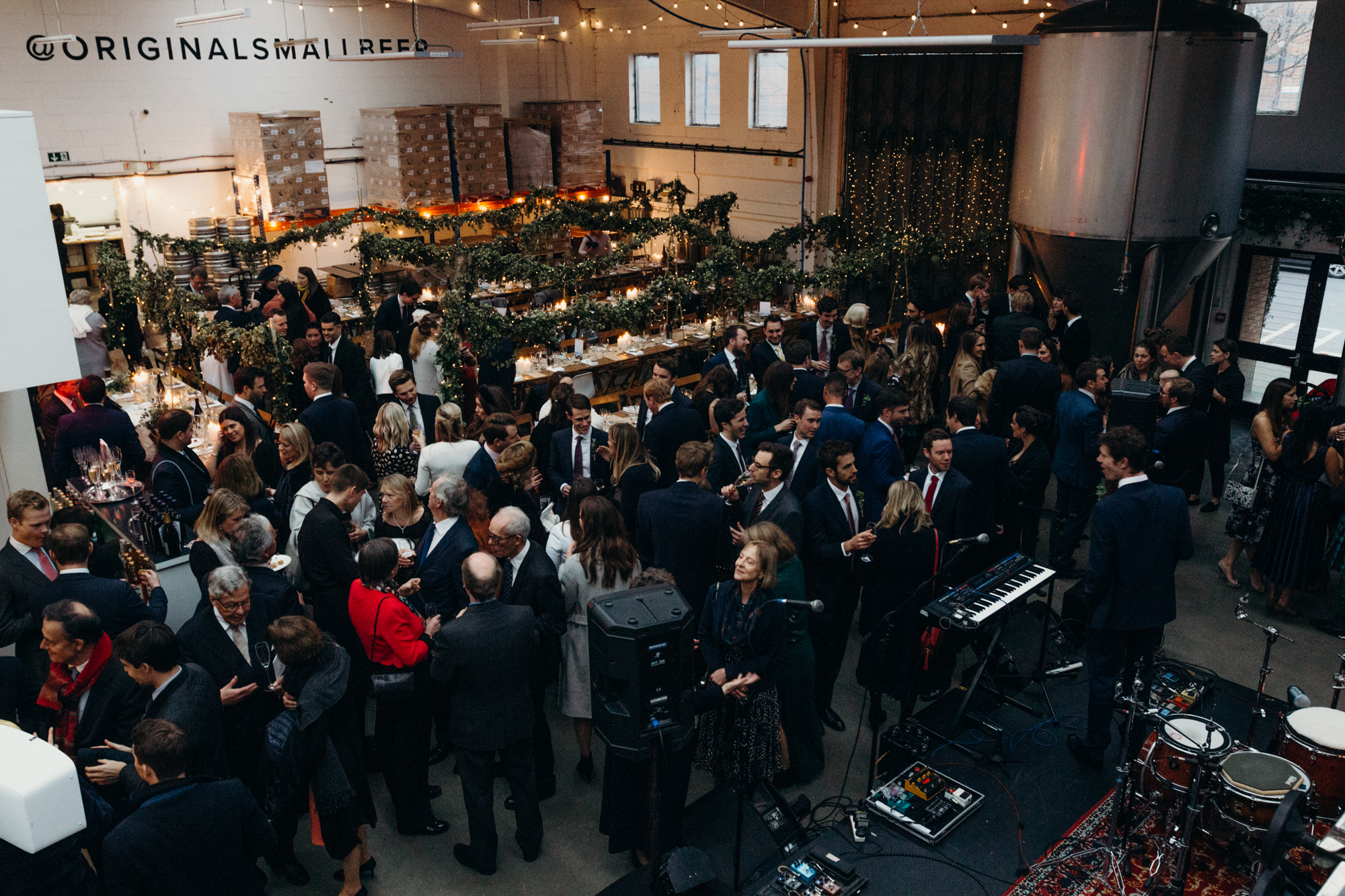 Networking event at Small Beer Brewery's Main Brew Room with elegant decor and live music. - Banner