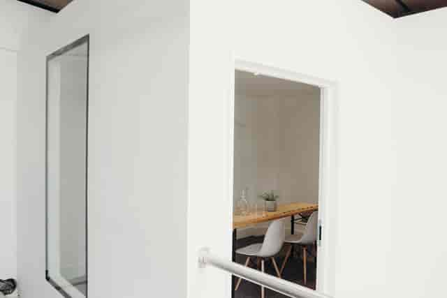 Modern meeting room with glass walls at Small Beer Brewery for team brainstorming sessions.