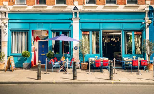 Vibrant outdoor venue with colorful facade for casual meetings and social events.