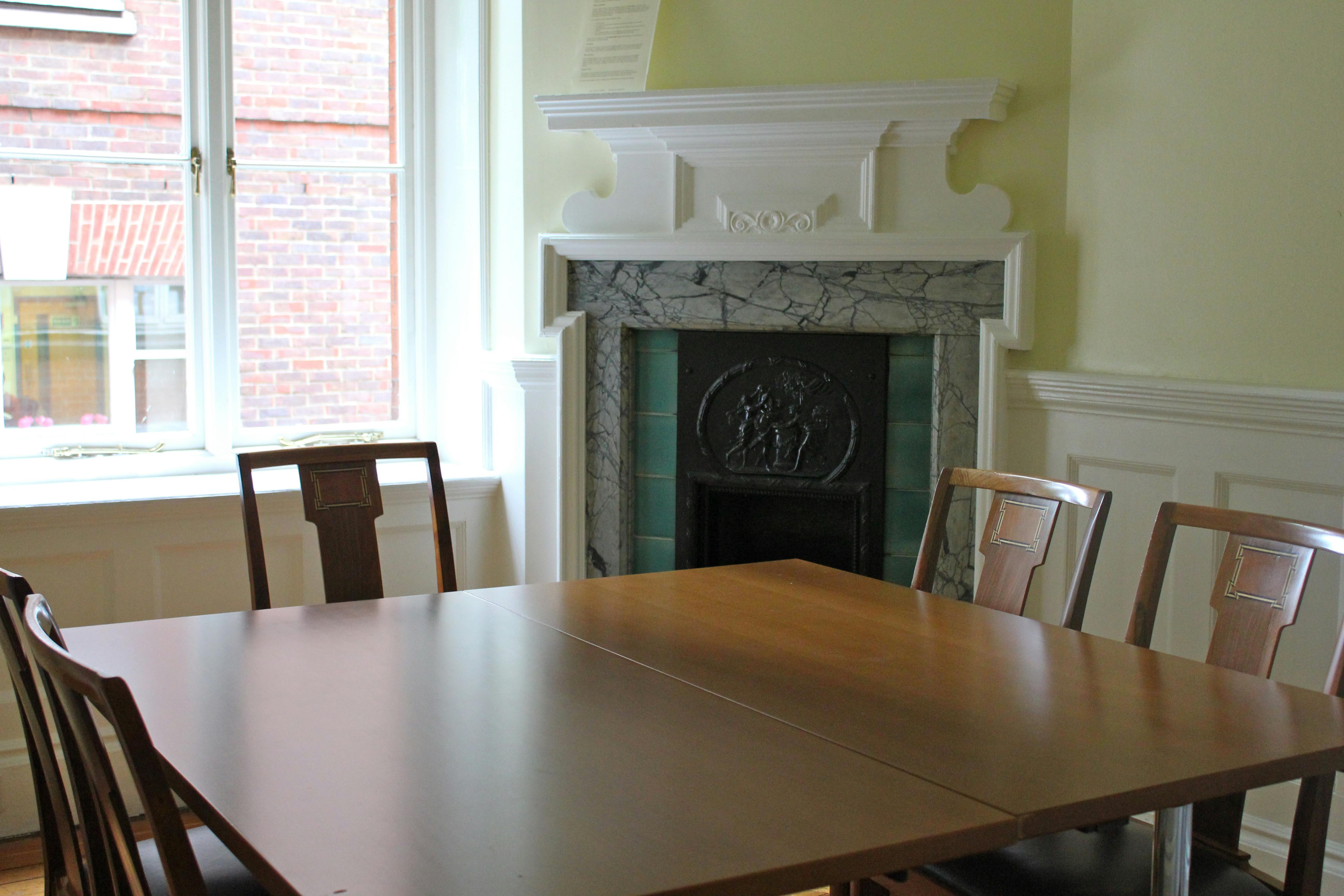 Caxton Room at St Bride Foundation: elegant meeting space with polished wooden table.