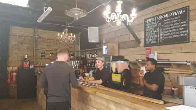 Stylish bar in Bermondsey for networking events with rustic decor and warm lighting.