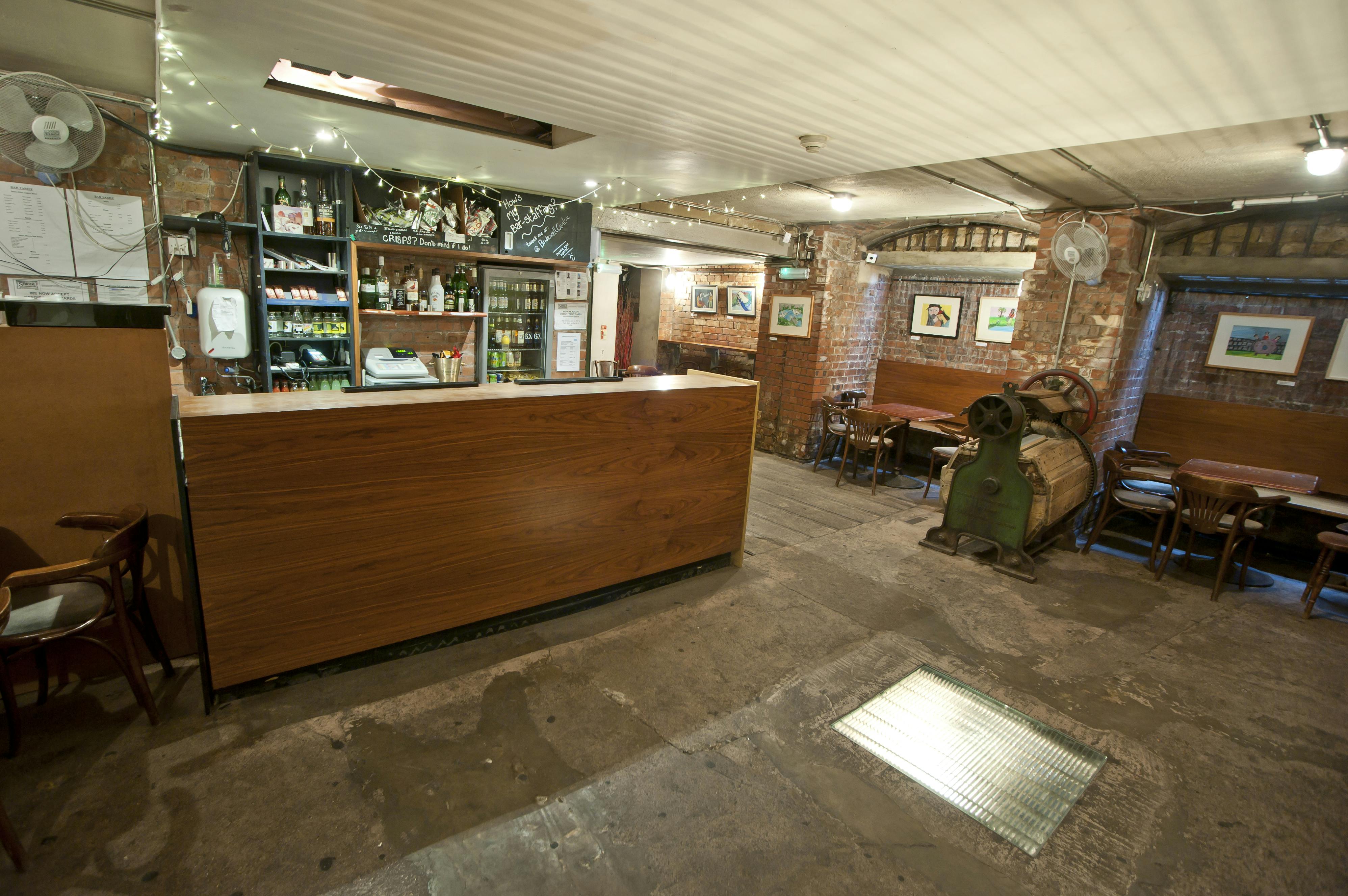 Cozy Theatre Bar at St Bride Foundation with rustic decor, ideal for intimate events.