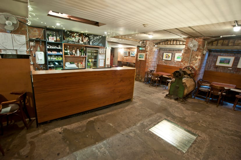 Cozy Theatre Bar at St Bride Foundation with rustic decor, ideal for intimate events.