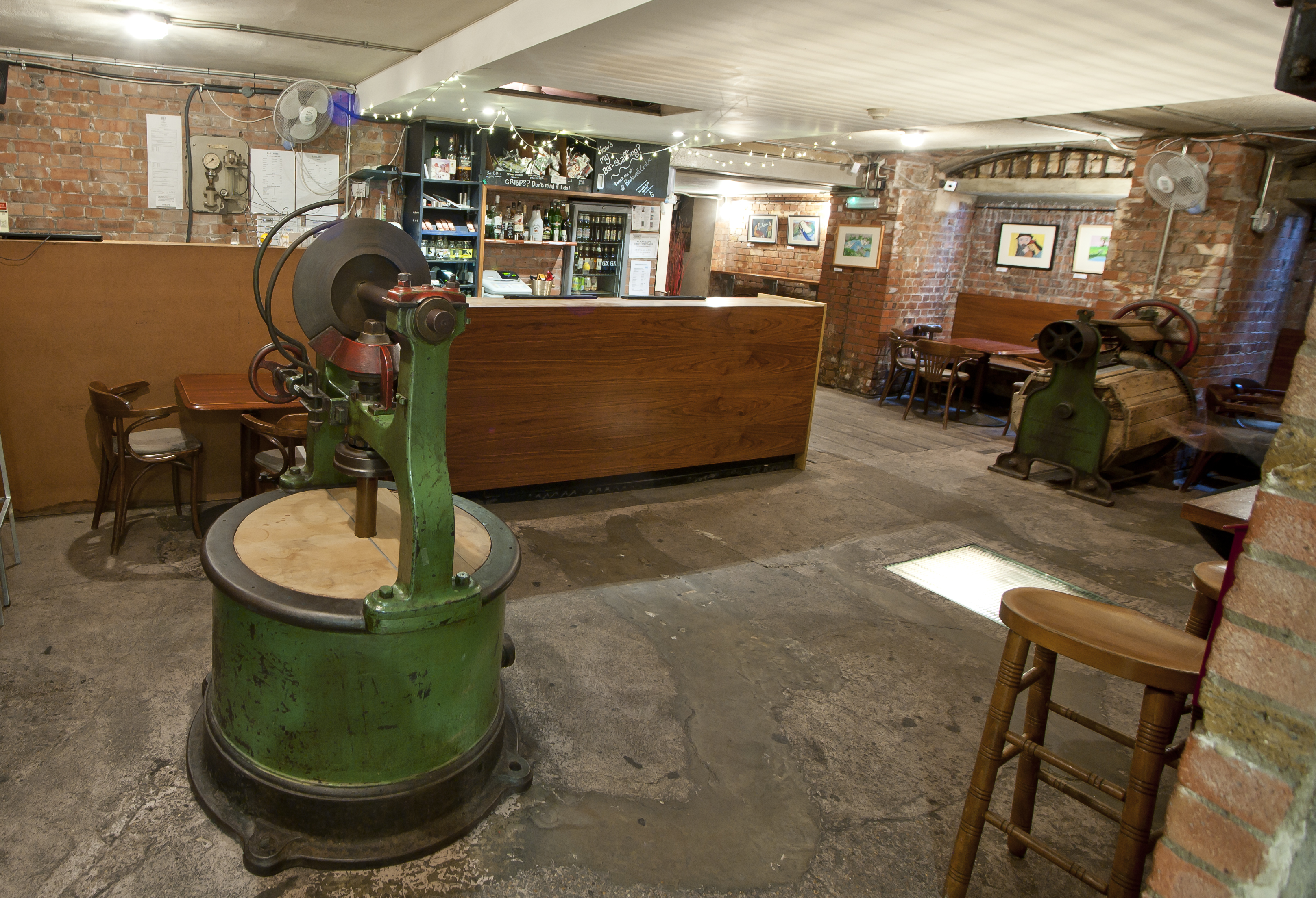Theatre Bar at St Bride Foundation: rustic venue with exposed brick, ideal for events and gatherings.