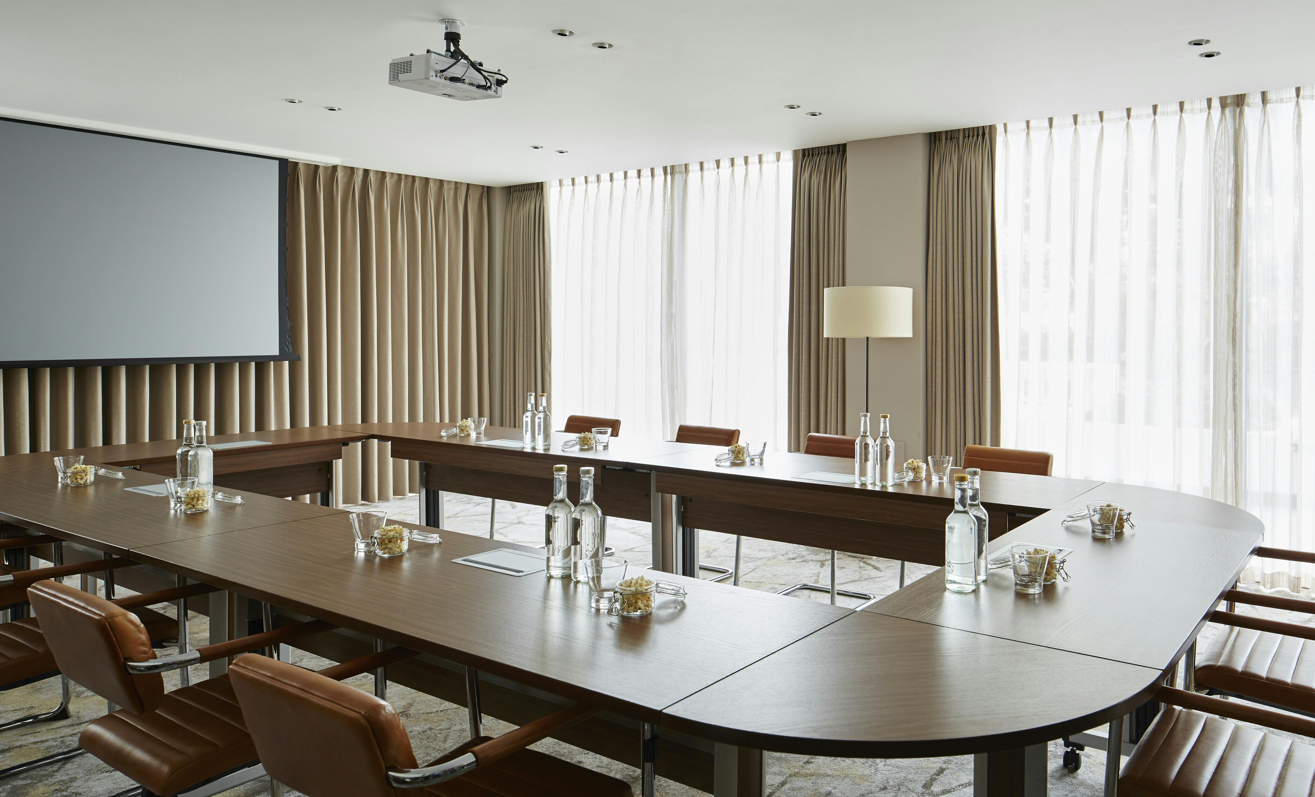 Modern meeting room at London Marriott Regents Park with natural light for professional events.