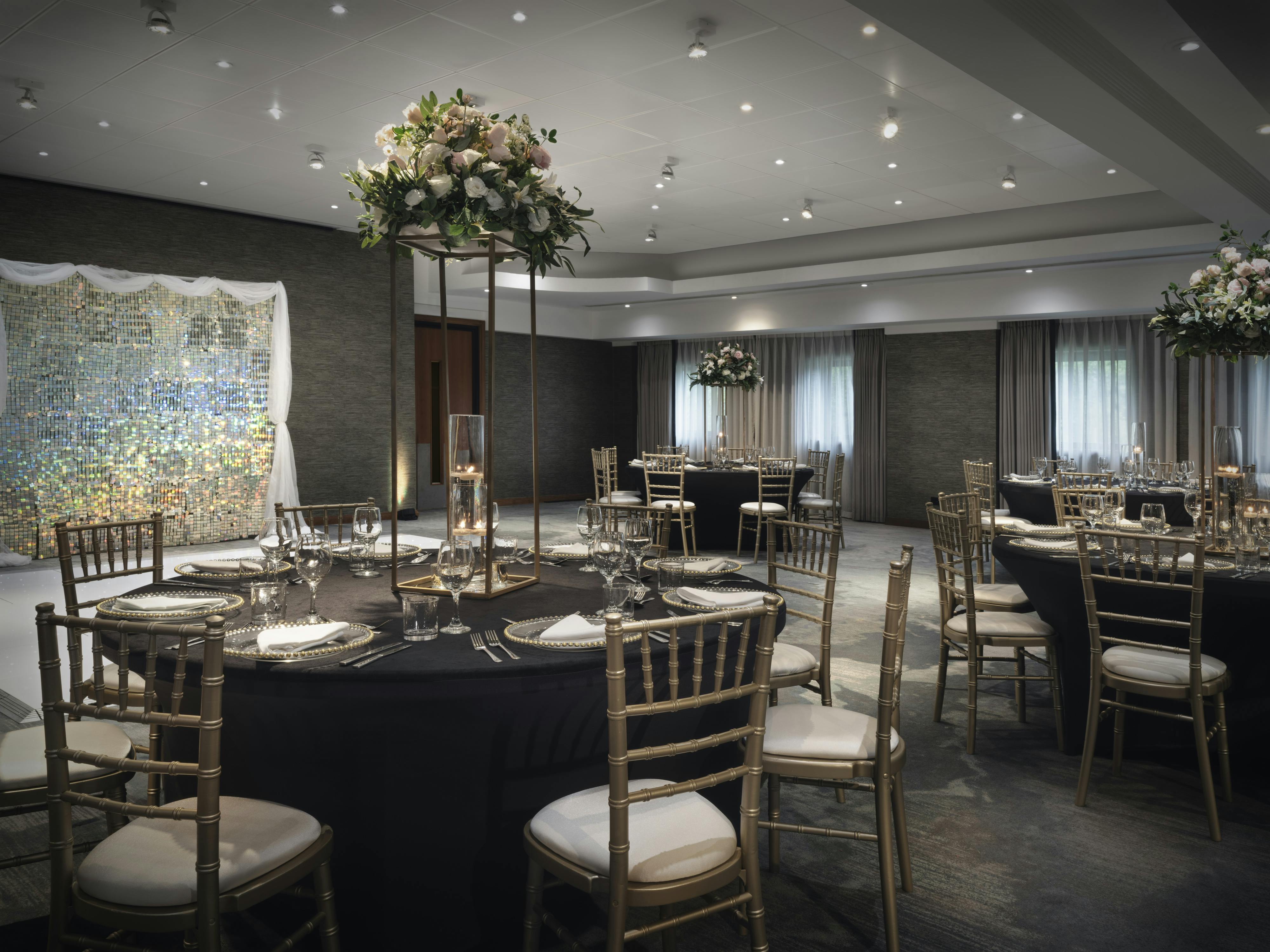 Cheshire Suite at Delta Hotels: elegant event space with floral centerpieces for weddings.