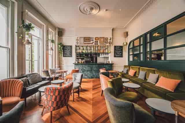 Stylish lounge area with natural light for networking events at THE PILGRM.