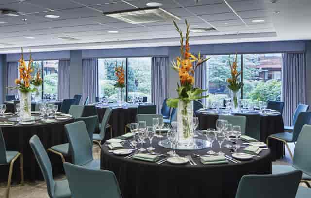 Rosewood Room at Delta Hotels: elegant event space with floral centerpieces for corporate meetings.