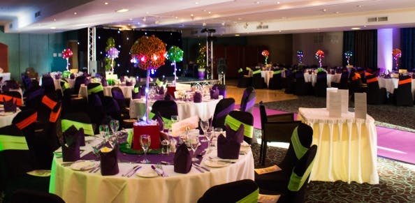 Elegant event space at Castle Green Hotel with purple accents and festive lighting.