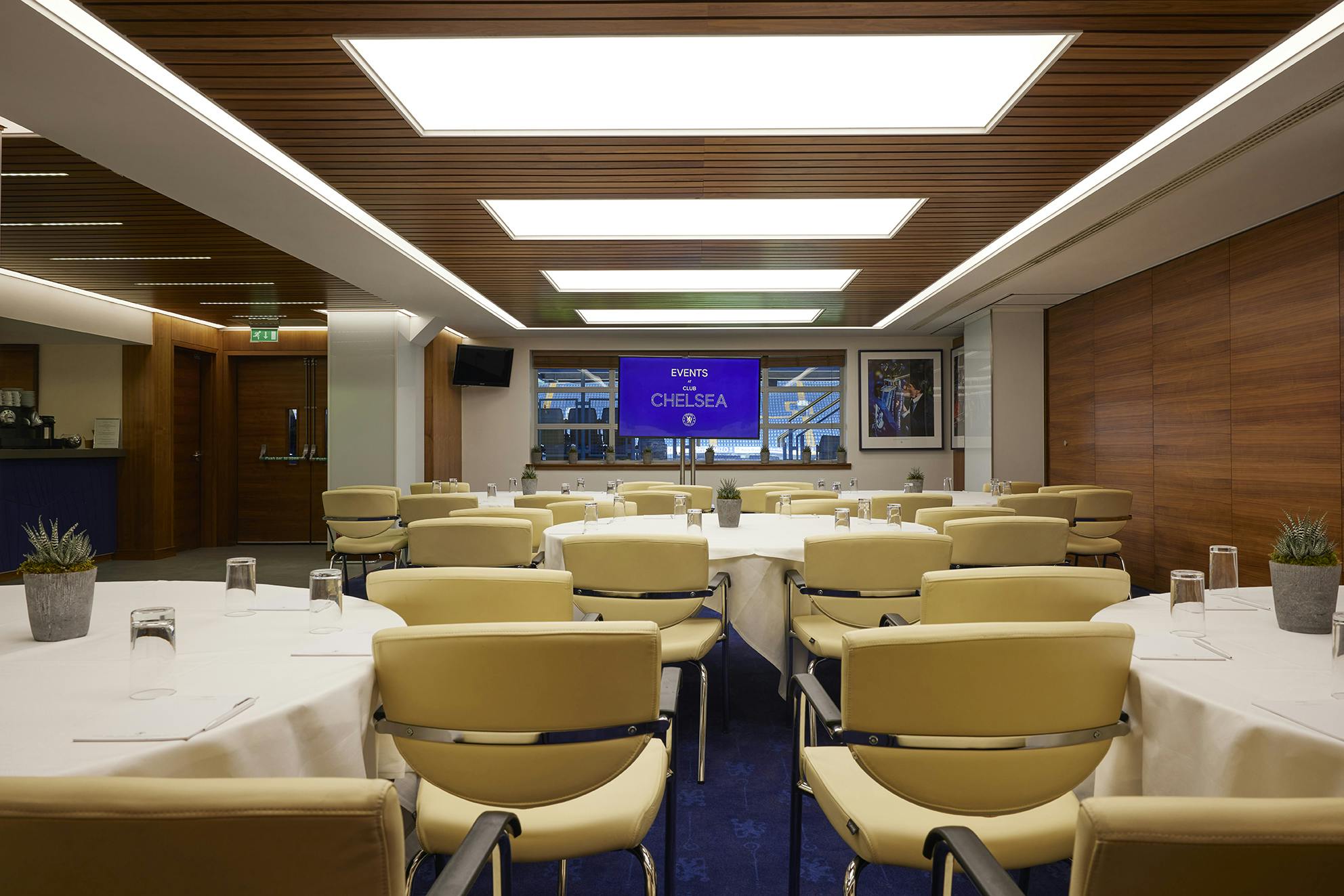 Vialli Suite at Chelsea FC: modern meeting room with round tables for corporate events.