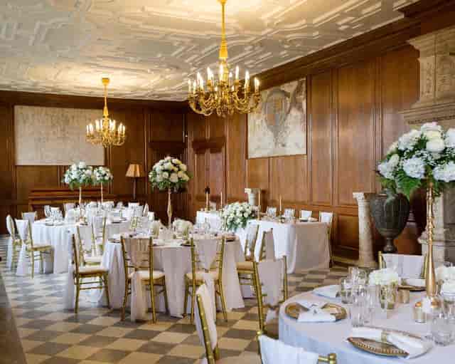 Elegant event space at The Mansion House with floral centerpieces, ideal for weddings.
