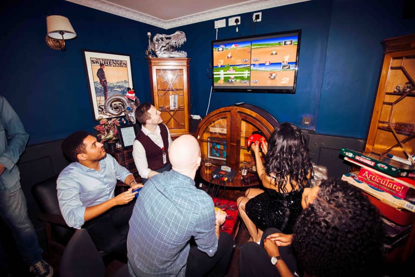 Vibrant social gathering in The Study, featuring retro decor and interactive gaming.