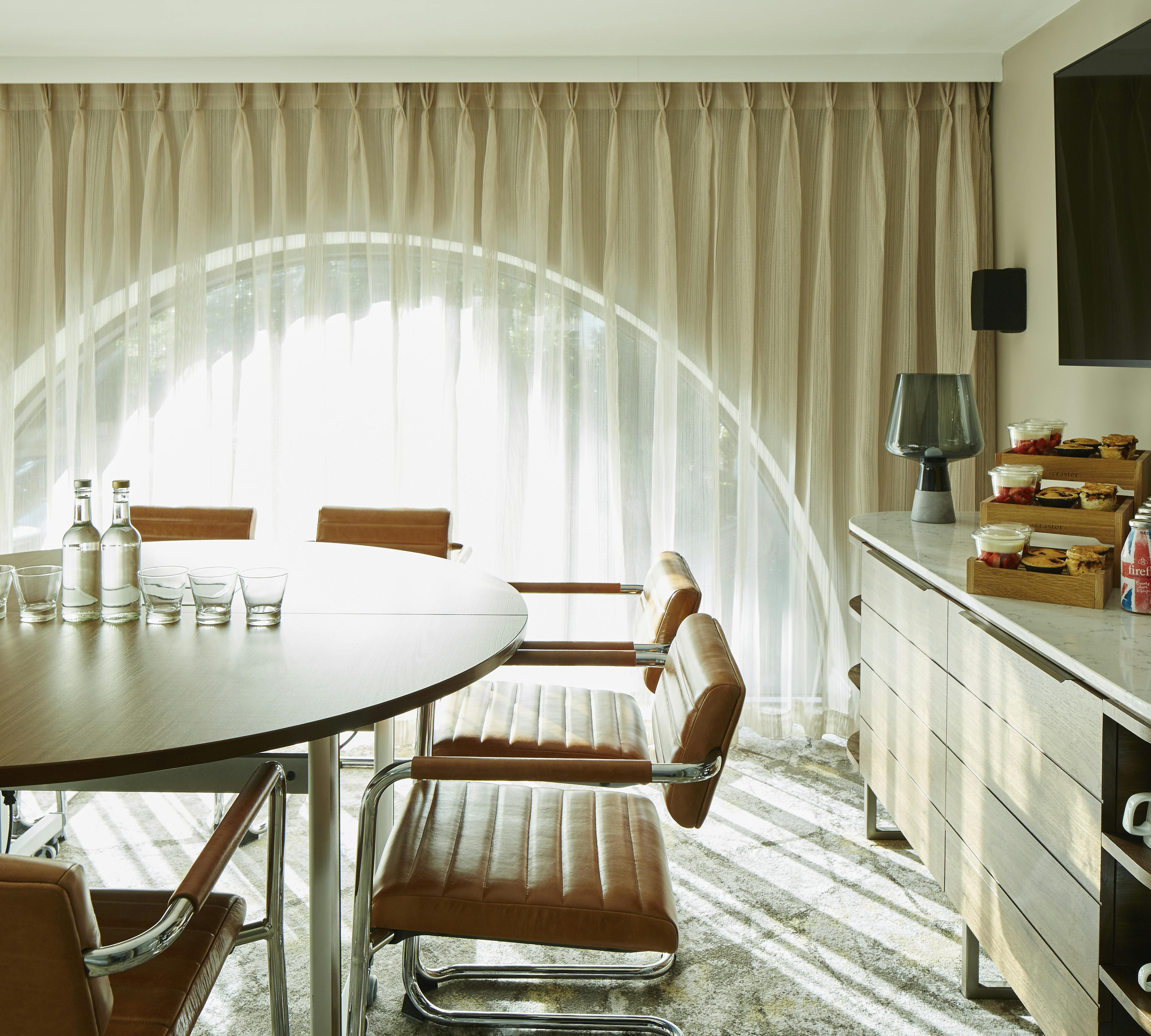 Hampstead meeting room at London Marriott, featuring a round table and natural light.