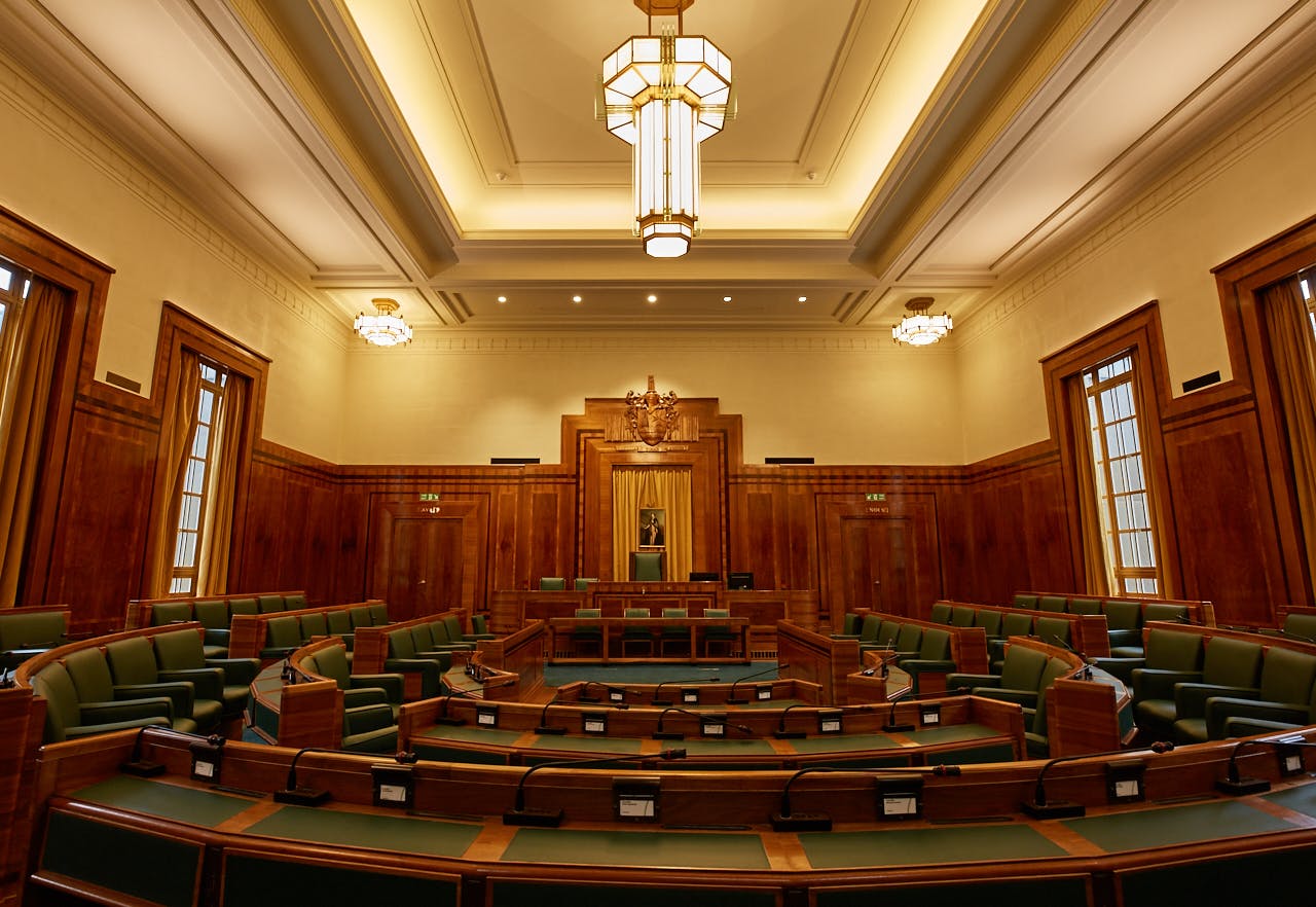 Council Chamber at Hackney Town Hall with elegant wood paneling, ideal for conferences.