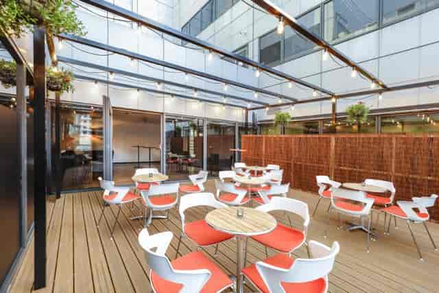 Modern Juniper Room outdoor terrace with string lighting for networking and corporate events.