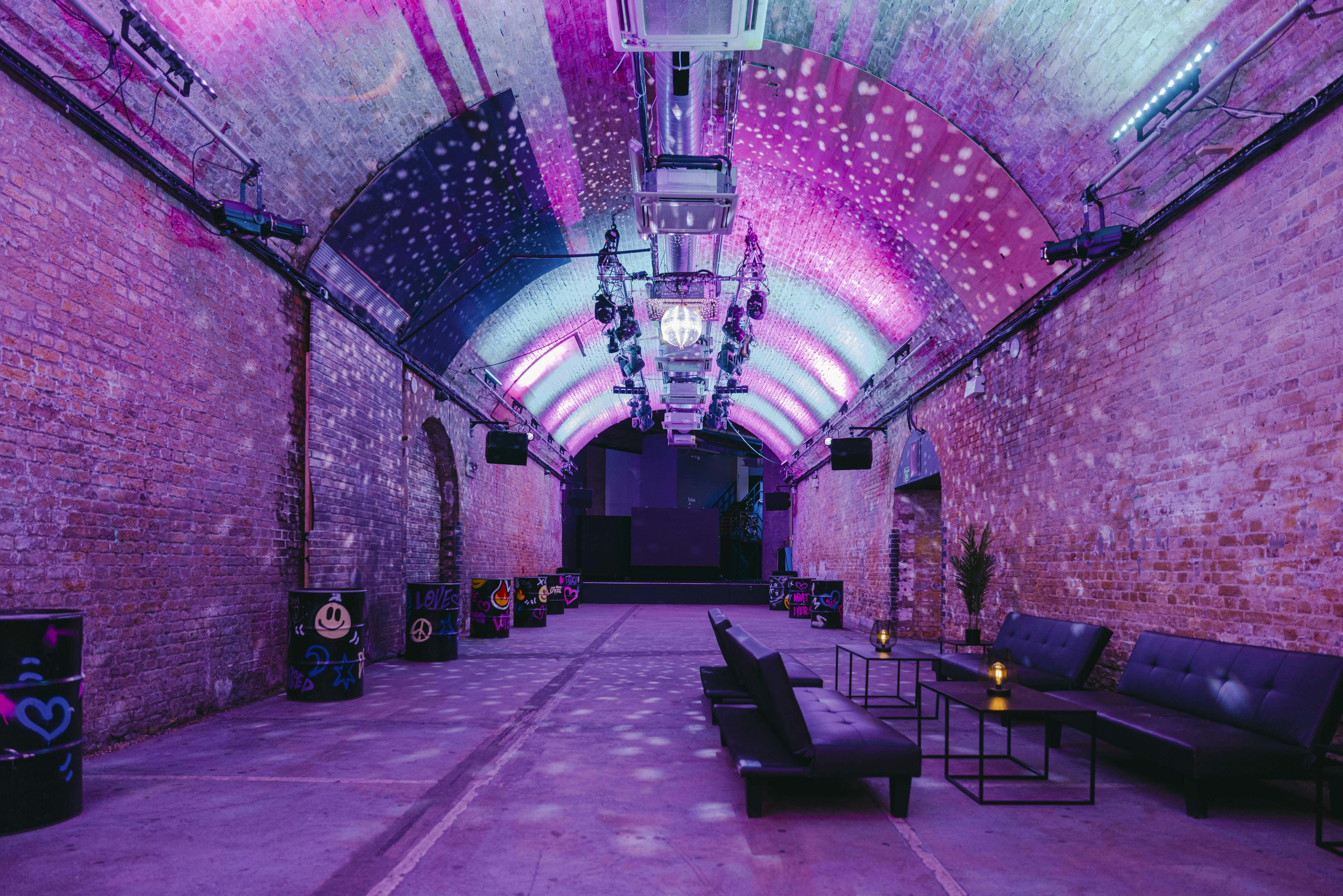 Industrial-chic event space with lounge seating, perfect for networking and parties.