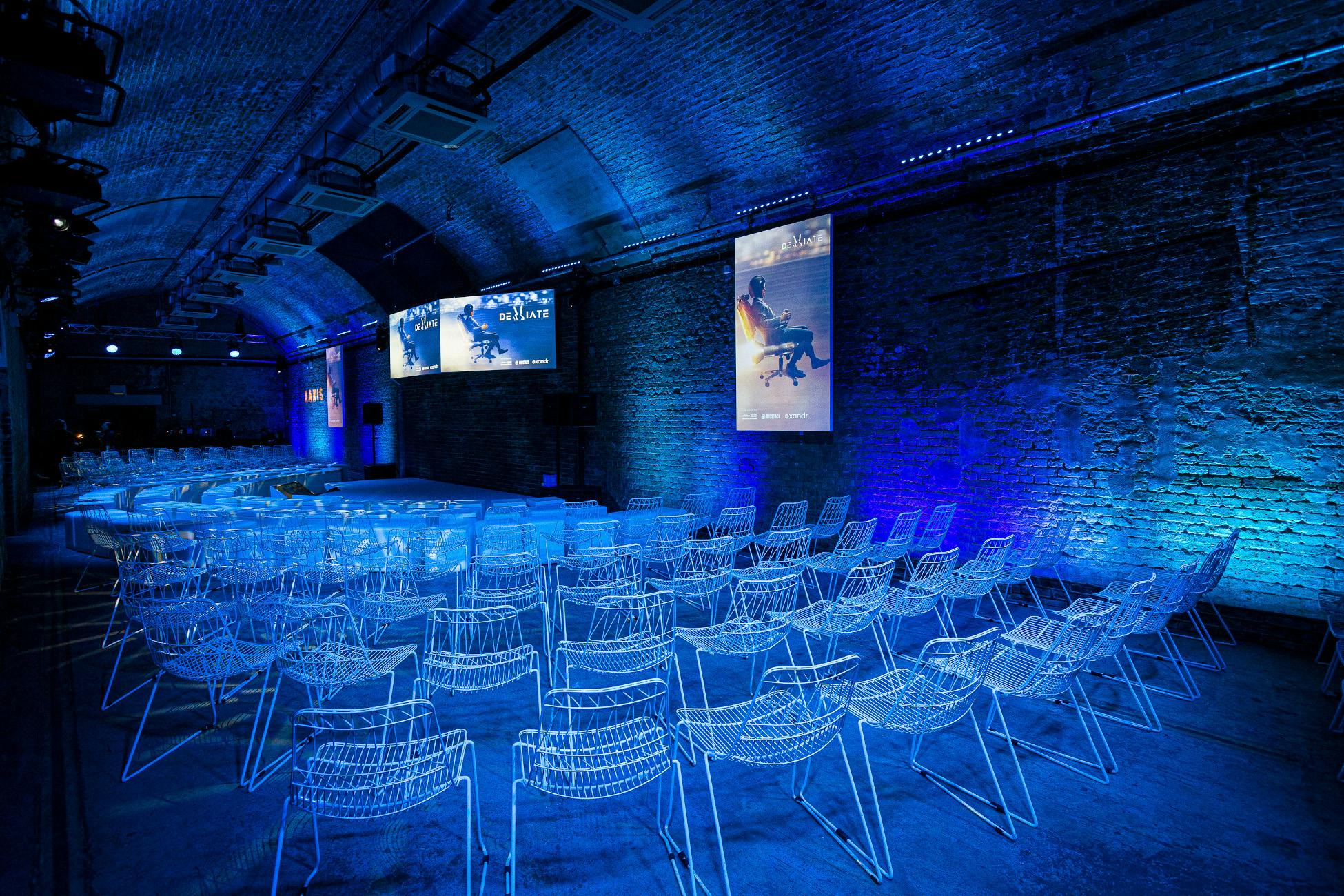 Modern event space with exposed brick walls, ideal for corporate events and workshops.