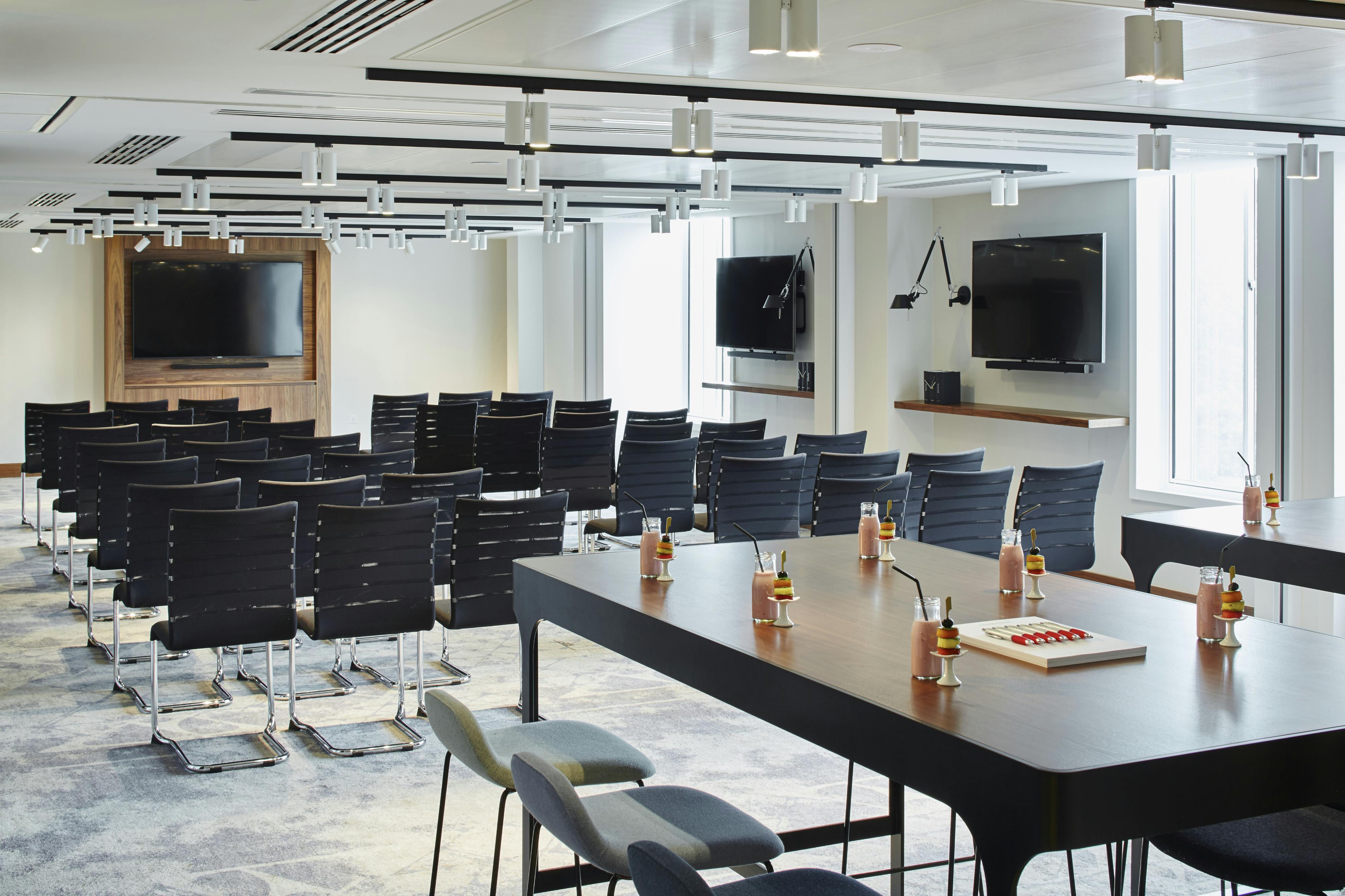 Modern meeting space at London Heathrow Marriott with sleek chairs and collaborative table.