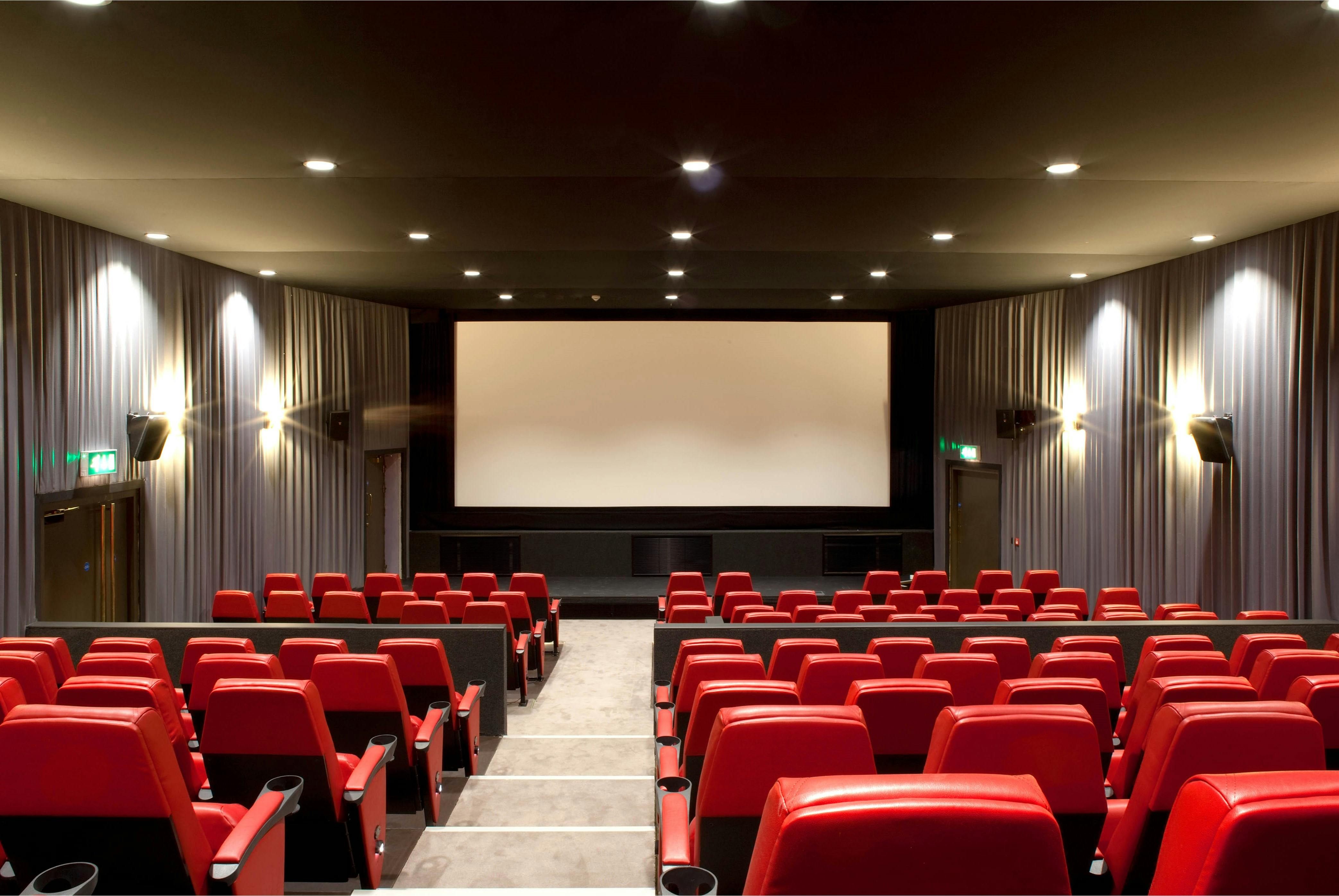 Modern cinema venue with red seating, ideal for film screenings and presentations.