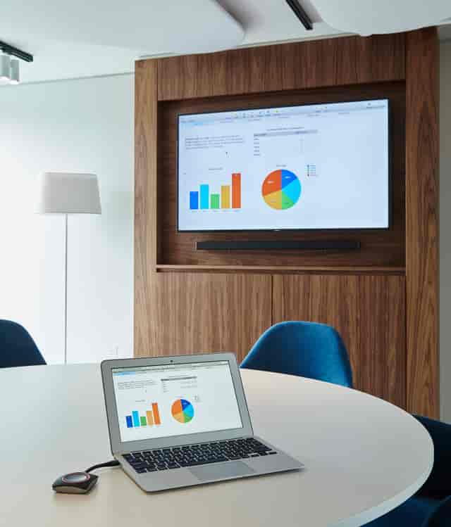 Cody in modern meeting space at London Heathrow Marriott with large screen for presentations.