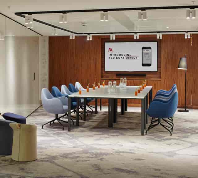 Modern meeting room at London Heathrow Marriott with digital display for events.