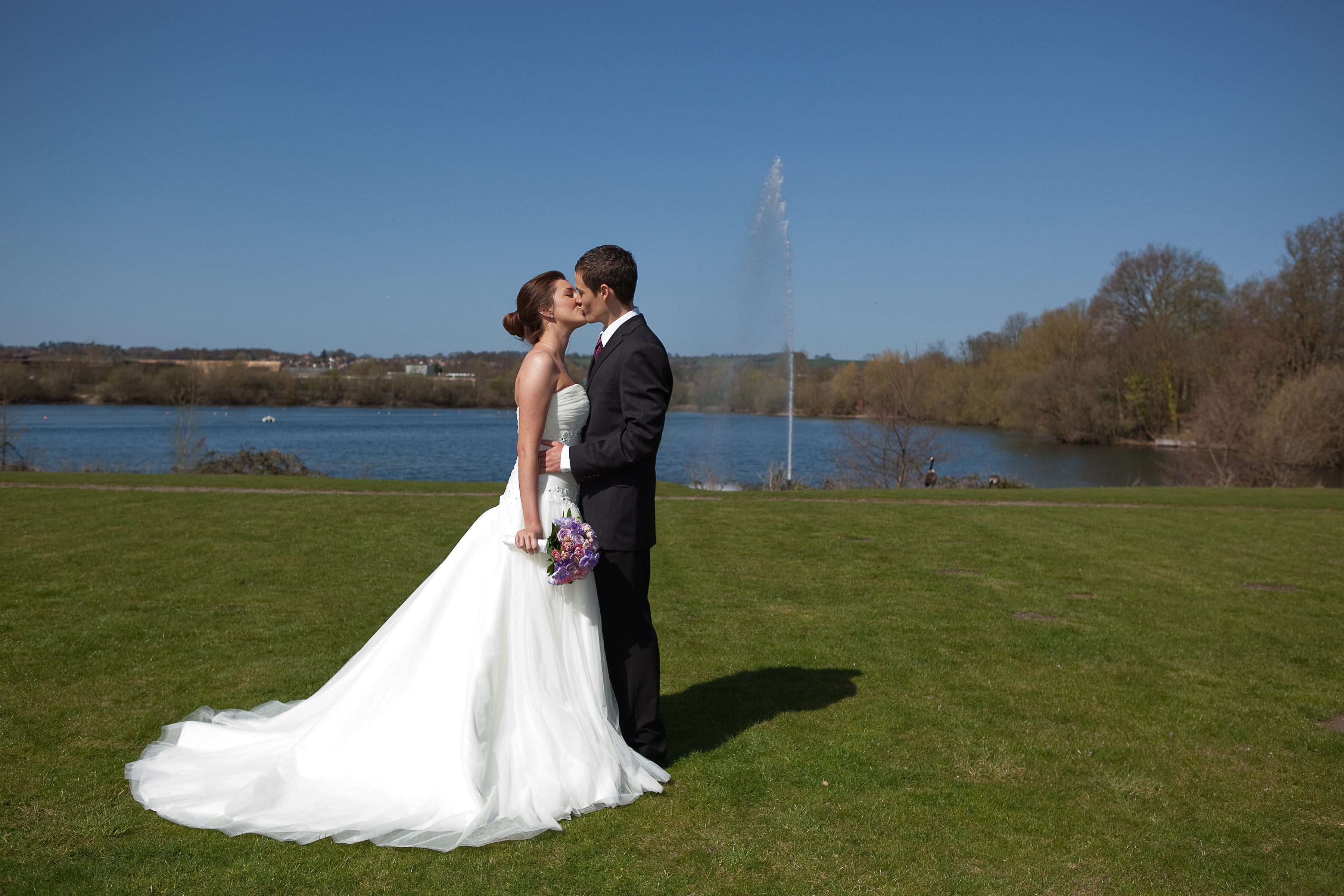 Outdoor wedding at Riverside 4, Crowne Plaza Marlow, with lake backdrop and lush lawn. - Banner