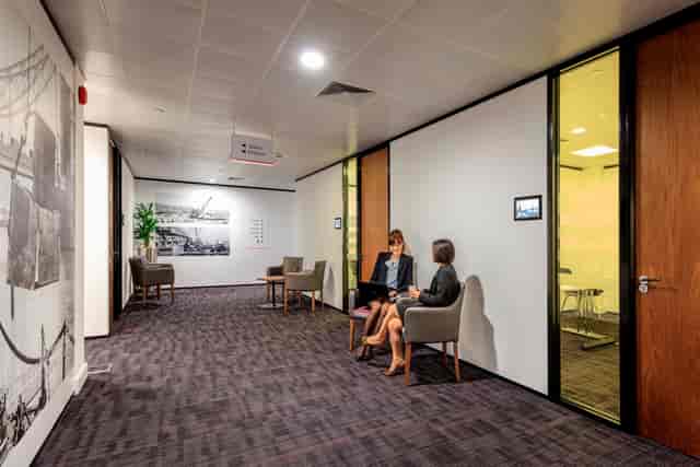 Modern corporate breakout area with seating, ideal for business meetings and networking events.