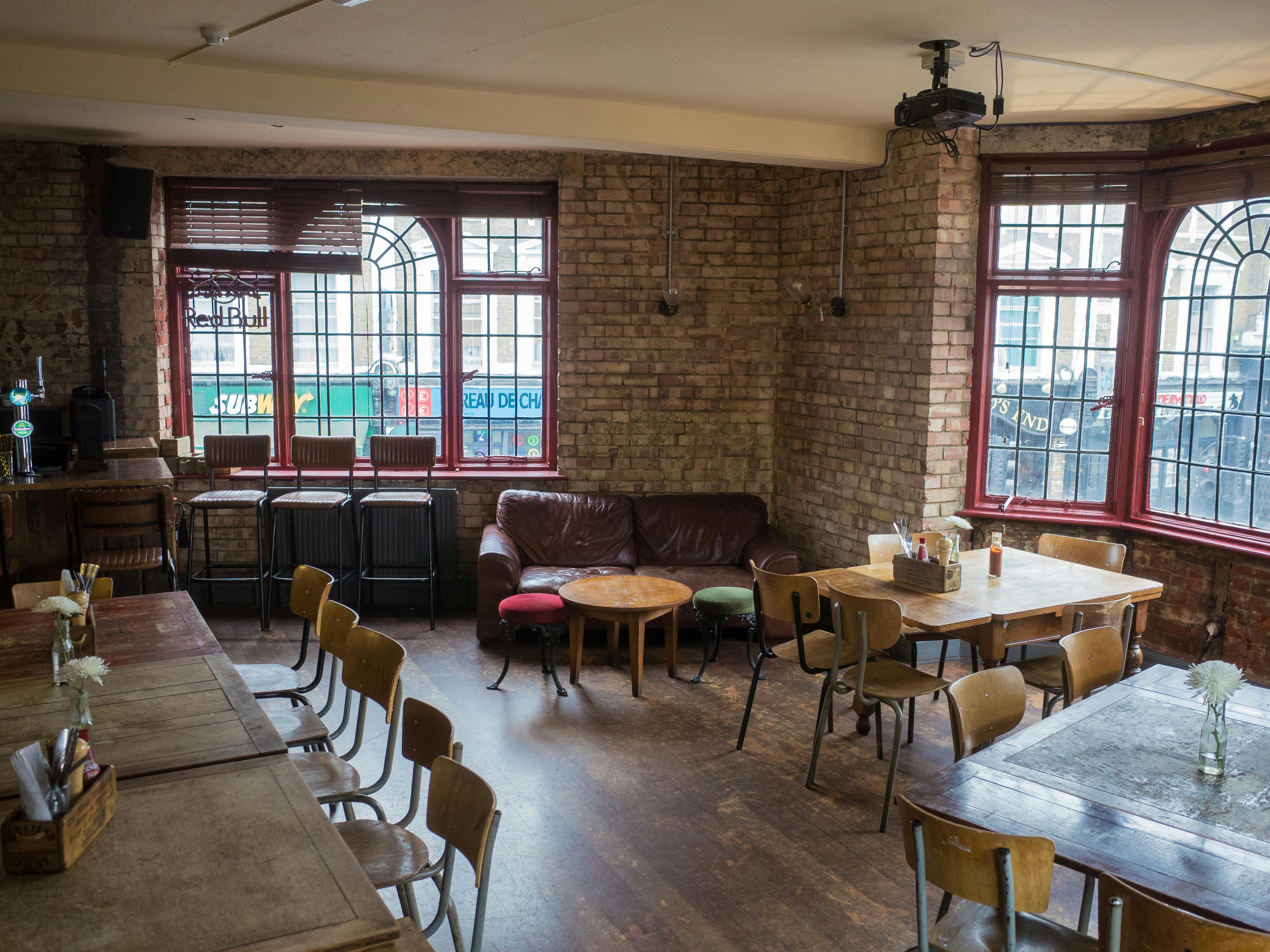 Cozy event space with exposed brick walls for meetings and gatherings at The Camden Eye.