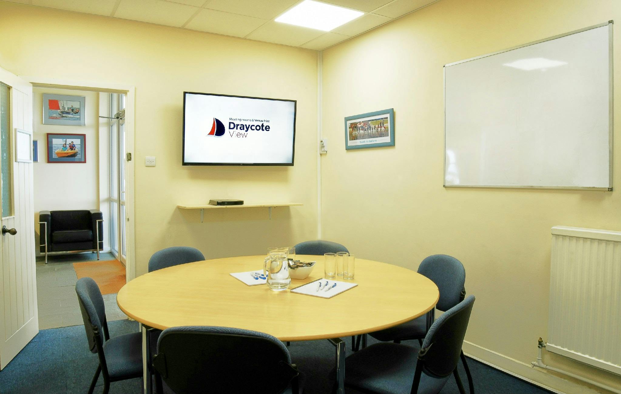 "Farborough Room at Draycote View: bright meeting space with round table for events."