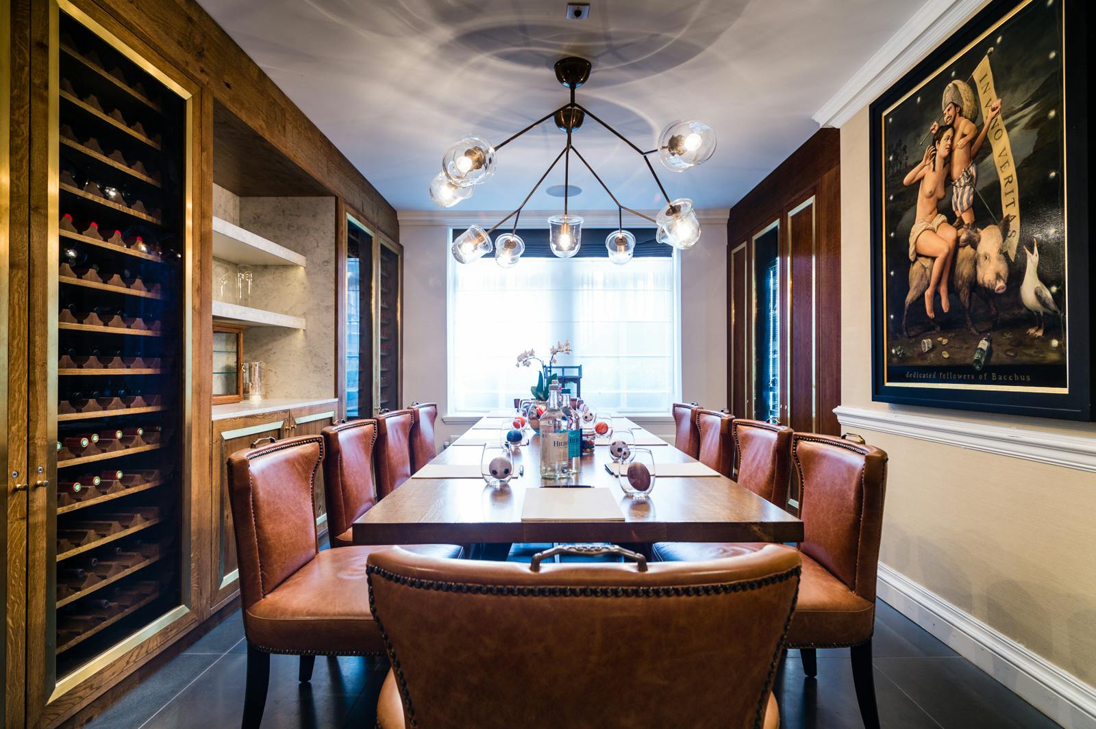 Elegant meeting space in The Ampersand Hotel with wooden table and leather chairs.