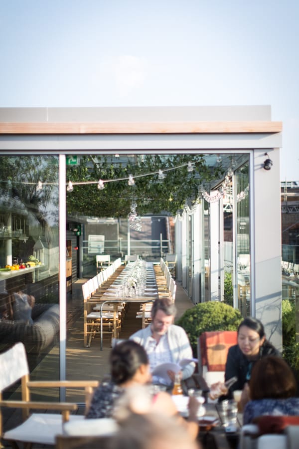 Stylish Boundary Rooftop event space with long dining table, perfect for networking gatherings.