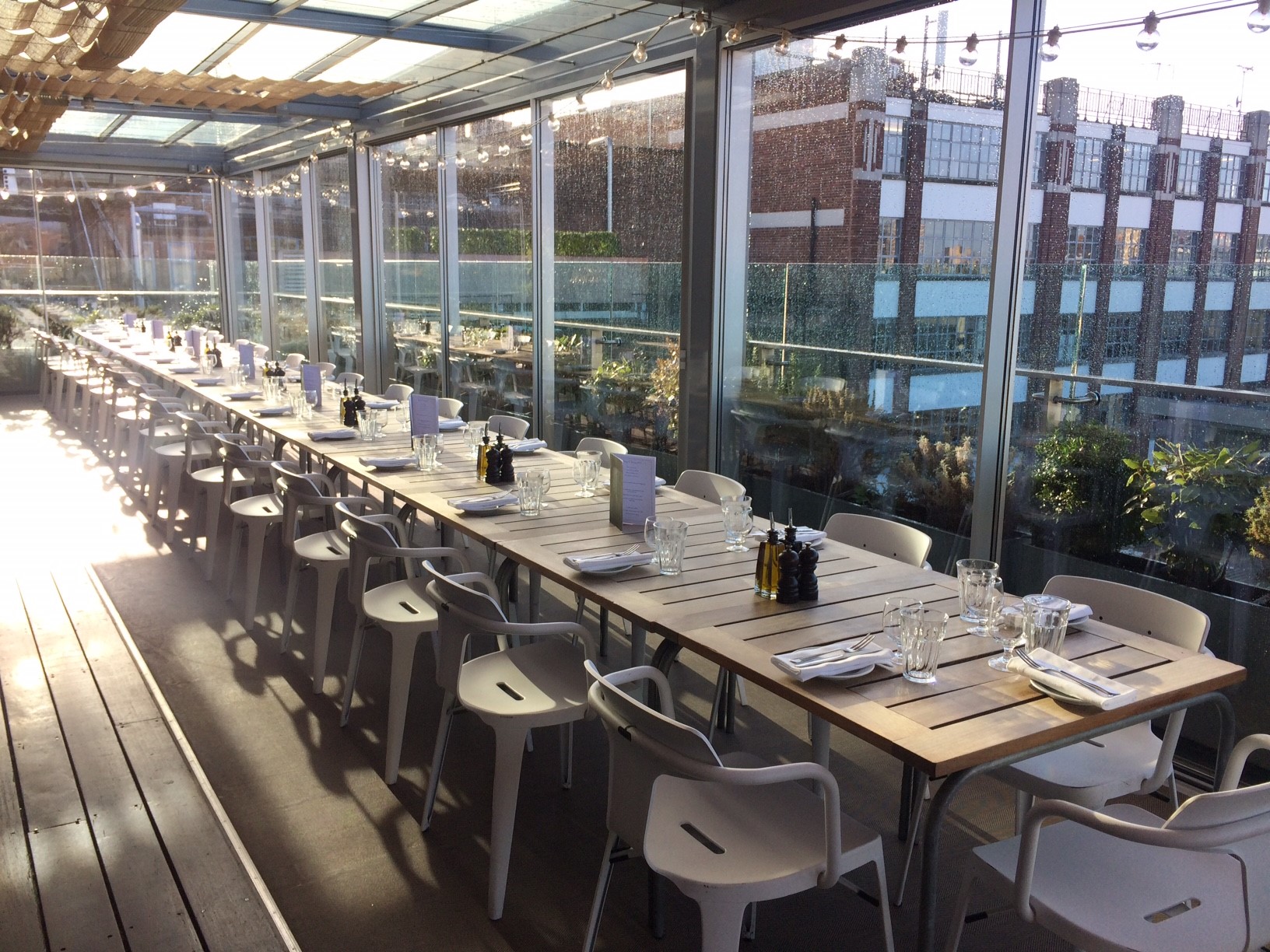 Elegant long table setup at Boundary Rooftop for networking and celebratory events. - Banner