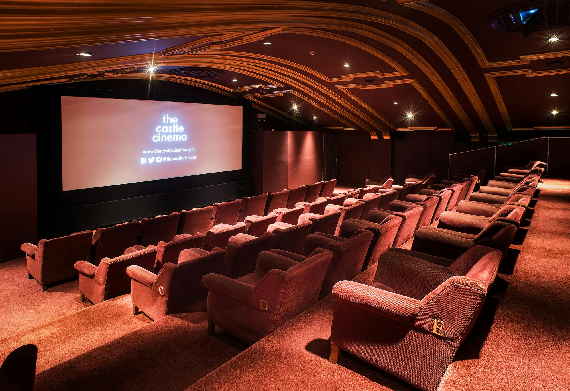 Cozy cinema with plush seating for private screenings and small group events.