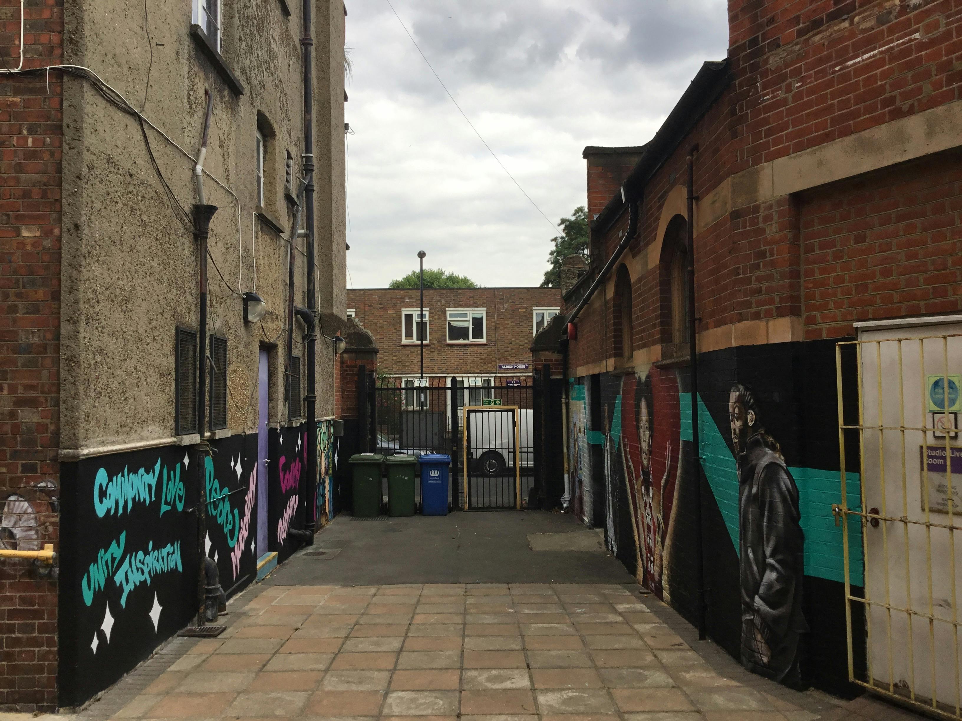 Vibrant alleyway with street art at The Midi Music Company for outdoor events.