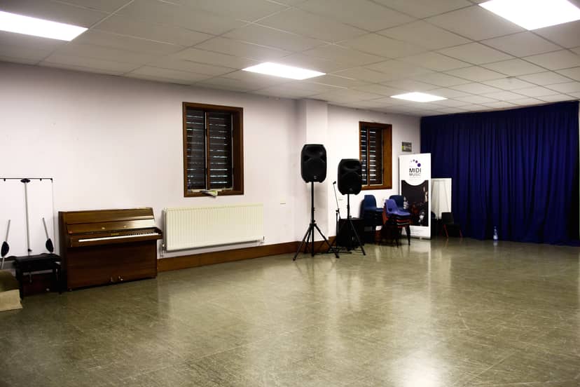 Versatile event space with polished floor, ideal for music performances and workshops.