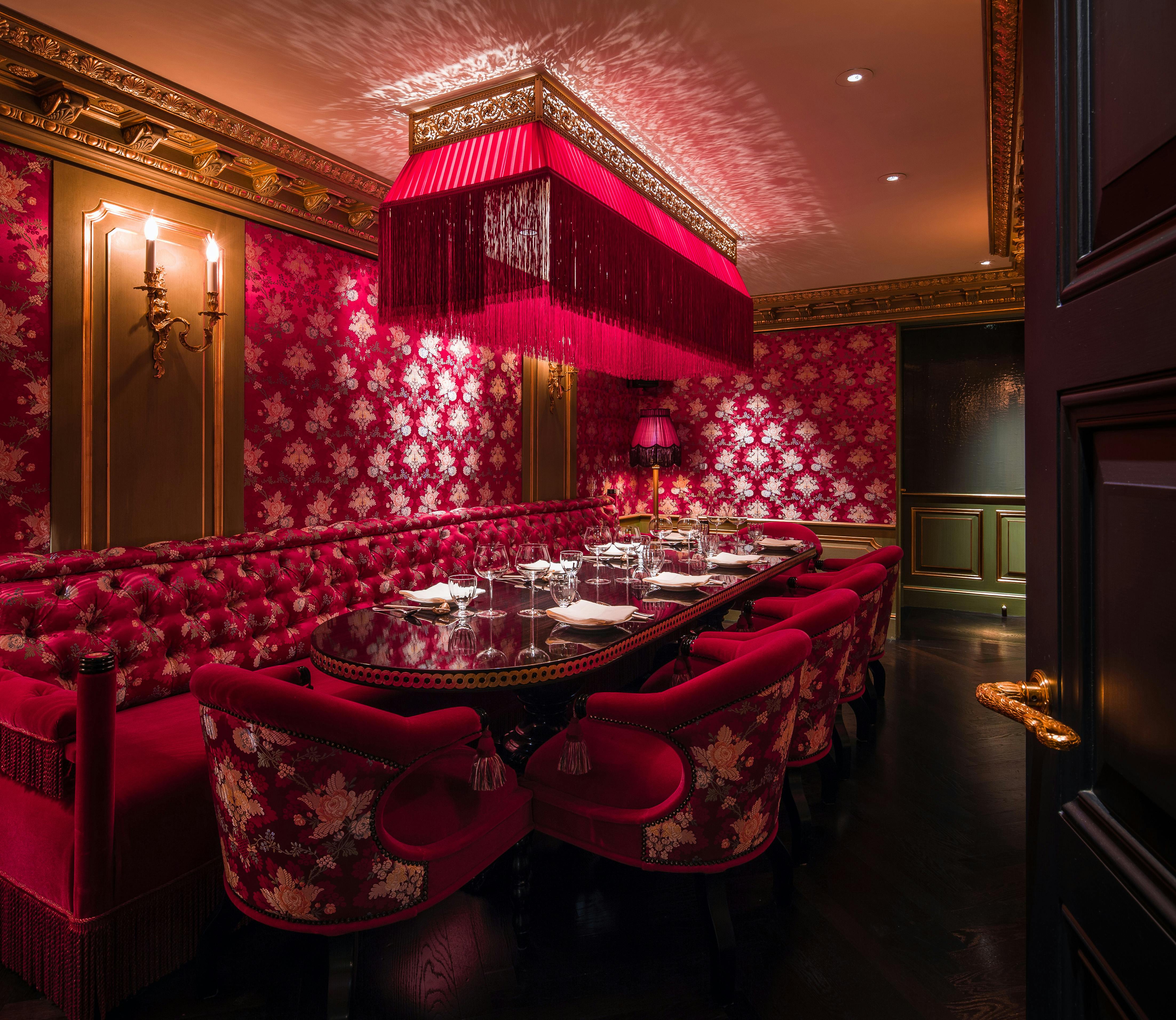 Opulent Salon Rouge dining space with rich red decor for exclusive events and corporate dinners.