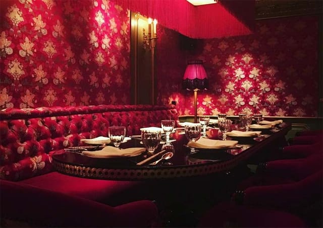 Intimate red dining space at Salon Rouge, perfect for private events and gatherings.