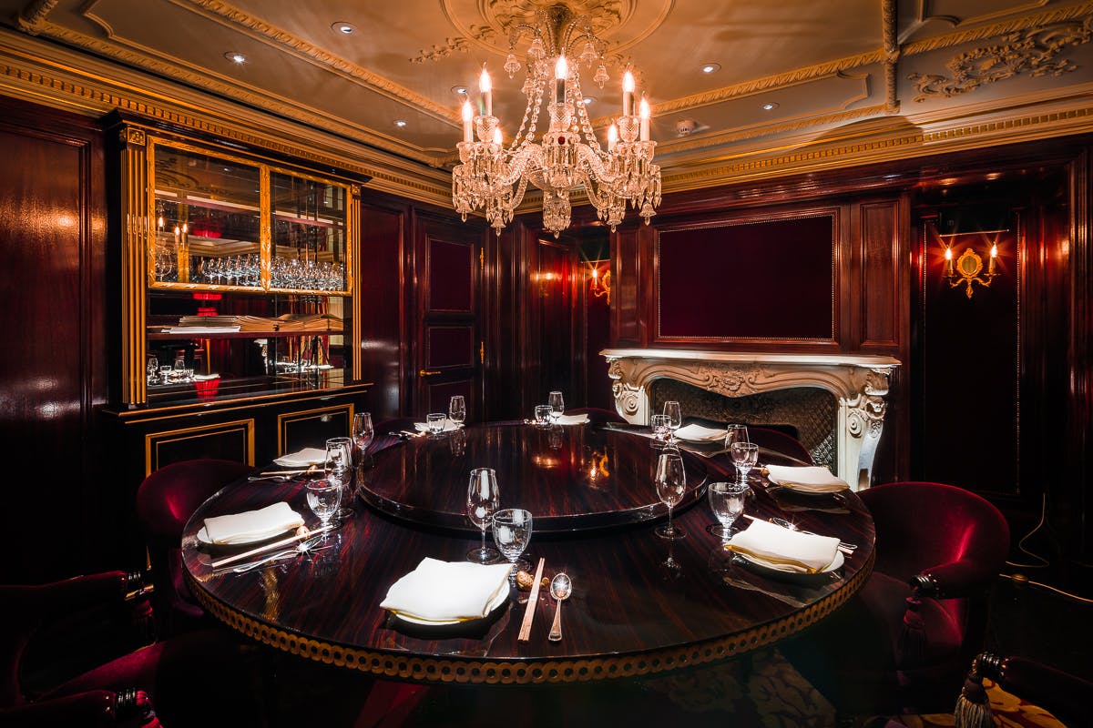 Elegant private dining room at Salon Noir, featuring rich wood paneling for corporate events.