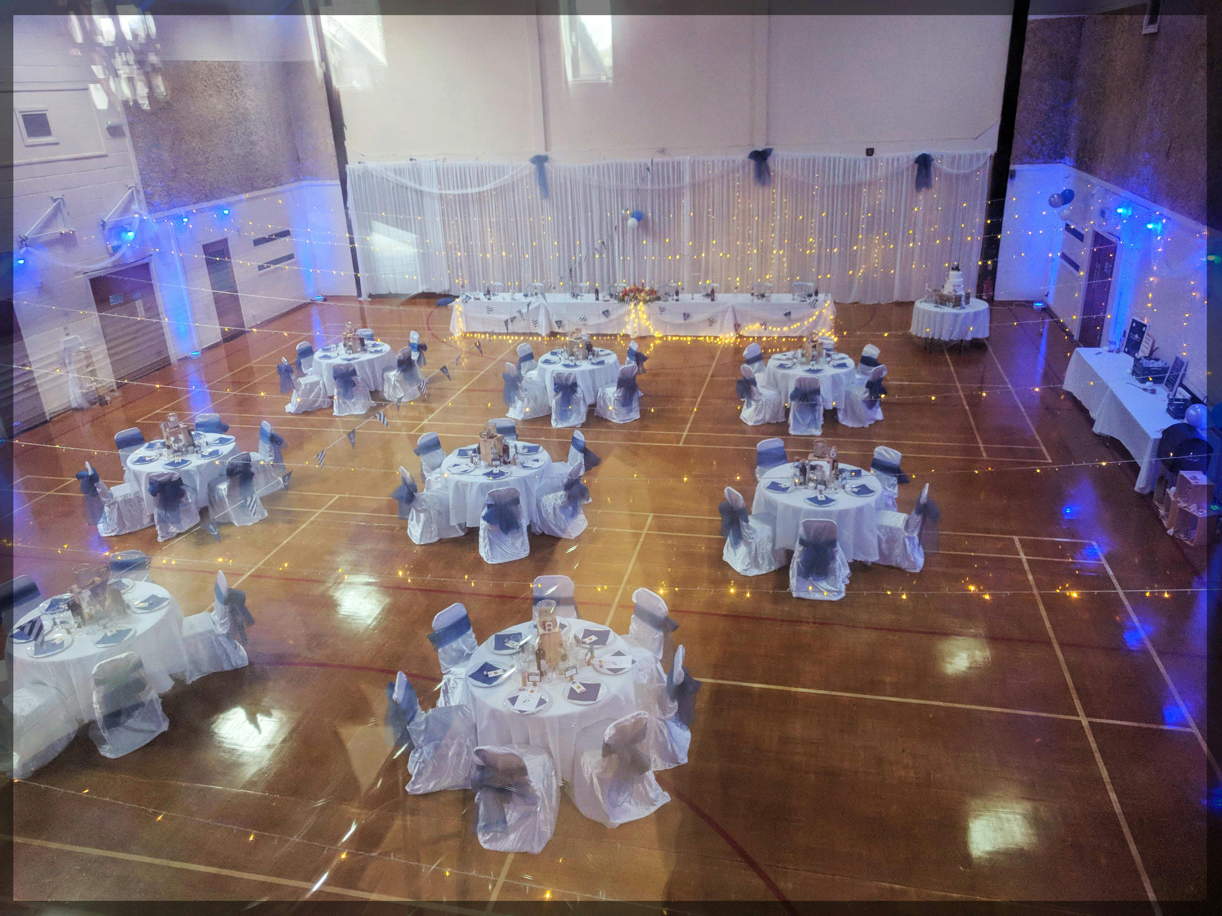 Main Hall at Wickham Community Centre, elegant wedding venue with round tables and soft lighting.