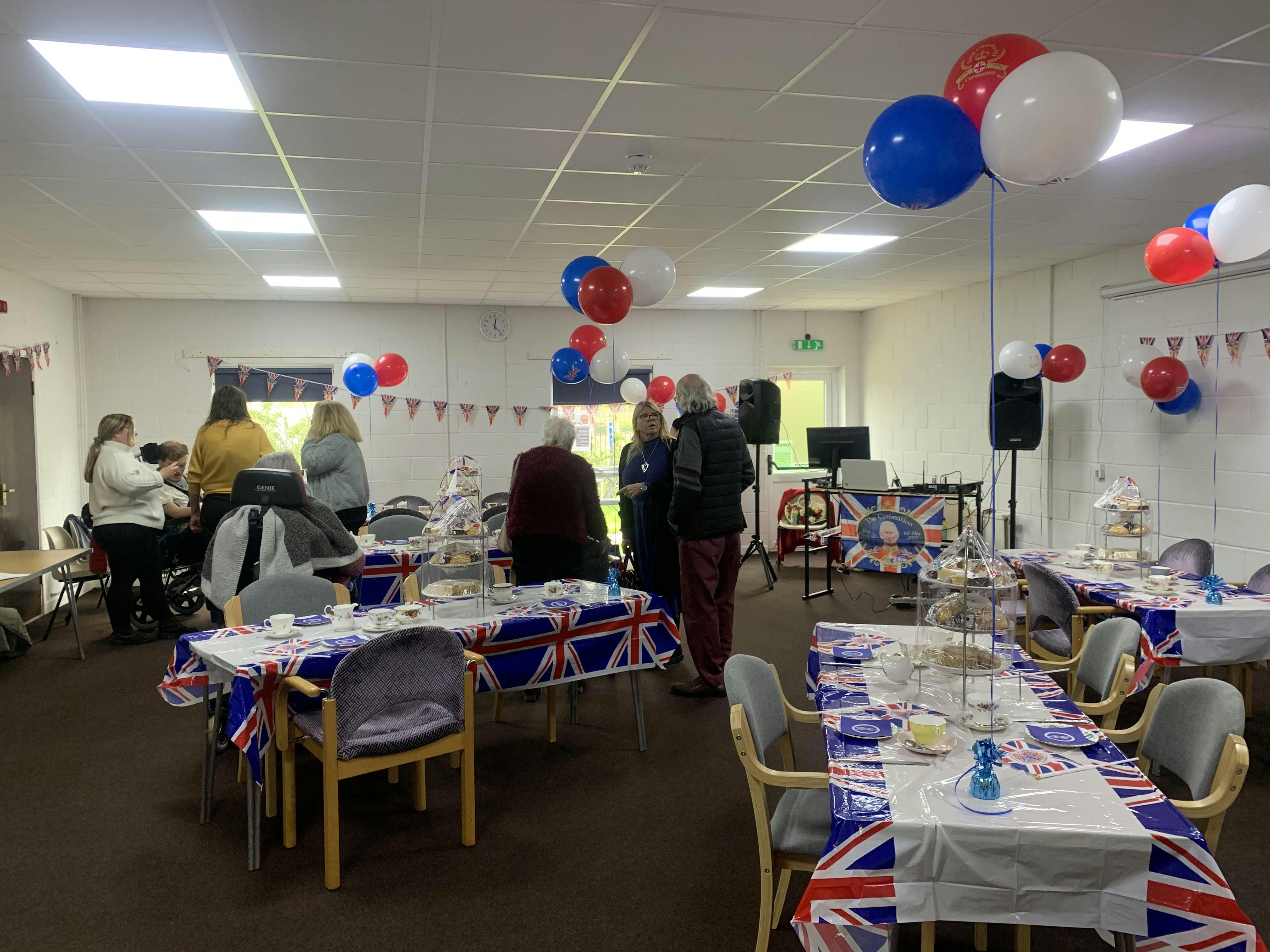 Houghton Room decorated for a festive gathering with Union Jack balloons and table settings.