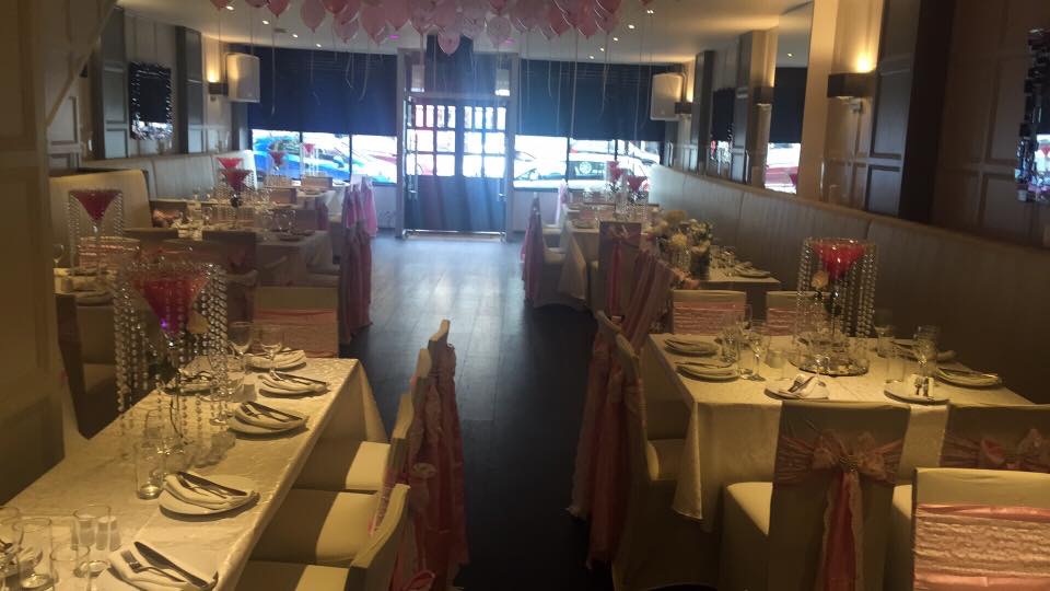 Elegant event space at Orama Restaurant with white linens, ideal for weddings and celebrations. - Banner